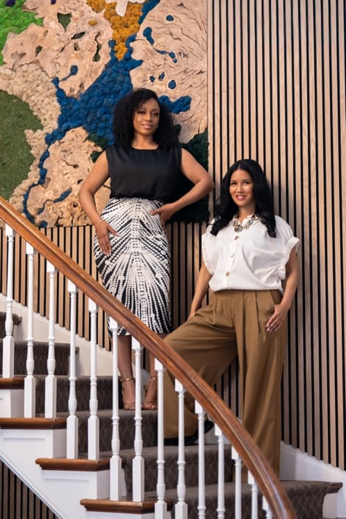 Ericka Charles and Nickie Alston on the staircase at the ASun Star offices.