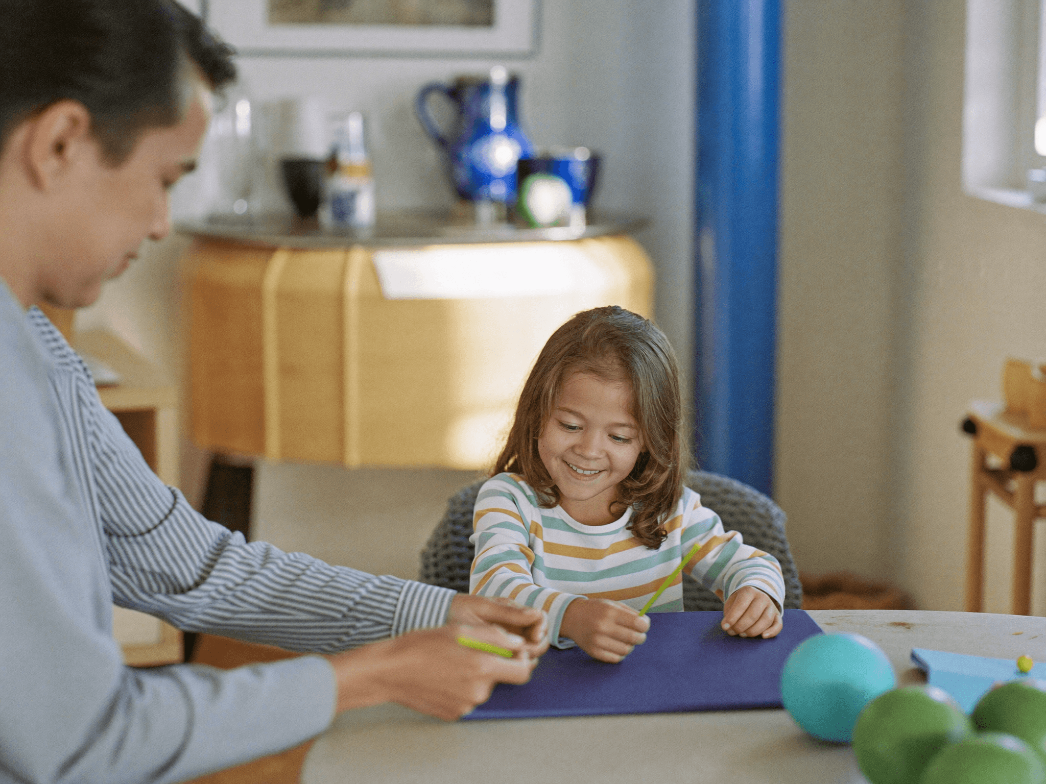 A father and daughter completing a craft activity together